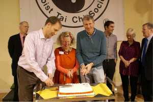 Jim Nicholson, Secretary of FLK, Philomena Pretsell, Vice President of the Taoist Tai Chi Society of Great Britain, and Kenny MacAskill MSP cut the celebration cake!